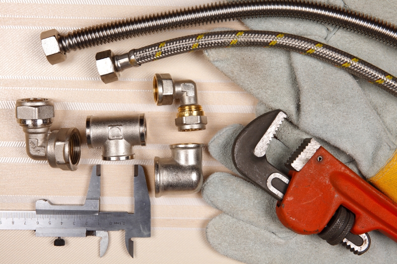 Plumber working on pipes in a Tufnell Park home